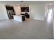 Open-concept space showcases a bright, spacious kitchen, and living area with modern tile flooring at 443 Cool Summer Ln, Davenport, FL 33837