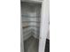 Walk-in pantry with adjustable shelving and tile flooring, providing ample storage space at 443 Cool Summer Ln, Davenport, FL 33837