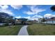 Community playground with sunshade, providing a fun and safe play area for children with lush green surroundings at 443 Cool Summer Ln, Davenport, FL 33837