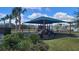 The well-equipped community playground offers a shaded area for children to play, surrounded by lush greenery at 443 Cool Summer Ln, Davenport, FL 33837