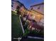 Well-manicured backyard featuring a pergola-covered patio with lush landscaping at 4447 Maple Chase Trl, Kissimmee, FL 34758