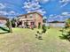 Backyard with a pergola and seating area, lush landscaping, and a white fence at 4447 Maple Chase Trl, Kissimmee, FL 34758