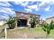 Backyard with a screened patio, pergola with seating, and lush tropical landscaping at 4447 Maple Chase Trl, Kissimmee, FL 34758