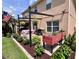 Backyard with a pergola, outdoor seating, brick pavers, and beautiful landscaping at 4447 Maple Chase Trl, Kissimmee, FL 34758