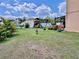 Large backyard with a playground, tropical foliage, and a well-manicured lawn at 4447 Maple Chase Trl, Kissimmee, FL 34758