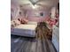 Charming bedroom with two beds, perfect for children or guests, adorned with colorful decor at 4447 Maple Chase Trl, Kissimmee, FL 34758