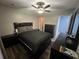 Comfortable bedroom with dark furniture, a ceiling fan, and ample closet space at 4447 Maple Chase Trl, Kissimmee, FL 34758