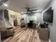 Inviting living room with wood floors, ceiling fan, and comfortable seating at 4447 Maple Chase Trl, Kissimmee, FL 34758