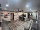 A spacious living room connected to the kitchen featuring an open floor plan and cohesive design at 4447 Maple Chase Trl, Kissimmee, FL 34758