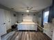Cozy main bedroom featuring a wooden bed frame and natural light from the window at 4447 Maple Chase Trl, Kissimmee, FL 34758