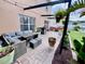 Outdoor patio features a comfortable seating area, brick pavers, and lush landscaping at 4447 Maple Chase Trl, Kissimmee, FL 34758
