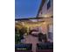 Backyard patio with pergola, string lights, and plants, perfect for outdoor entertaining at 4447 Maple Chase Trl, Kissimmee, FL 34758