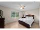 Bright bedroom with a large window, comfortable bed, bedside table and neutral color, creating a serene atmosphere at 4505 Kissimmee Park Rd, St Cloud, FL 34772