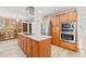 Modern kitchen featuring stainless steel appliances, granite countertops, an island, and ample cabinet space at 4505 Kissimmee Park Rd, St Cloud, FL 34772