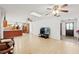 Spacious living area with light wood flooring and partial view of the kitchen at 4505 Kissimmee Park Rd, St Cloud, FL 34772