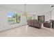 Bright living room featuring neutral walls, light-colored flooring, and large windows with scenic views at 4505 Kissimmee Park Rd, St Cloud, FL 34772