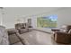 Bright living room featuring neutral walls, light-colored flooring, and large windows with scenic views at 4505 Kissimmee Park Rd, St Cloud, FL 34772