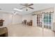 Open living area with light wood flooring, ceiling fans, and glass doors leading to the outside at 4505 Kissimmee Park Rd, St Cloud, FL 34772