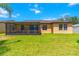 Spacious backyard with green grass and a screened-in patio at 4720 Doral Pointe Dr, Kissimmee, FL 34758
