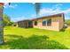 Lush backyard with a screened patio providing serene outdoor living at 4720 Doral Pointe Dr, Kissimmee, FL 34758