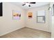 This bedroom offers laminate wood flooring, neutral walls adorned with modern art, and a ceiling fan for added comfort at 4720 Doral Pointe Dr, Kissimmee, FL 34758