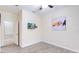 This bedroom showcases a ceiling fan, light wood floors, modern artwork, and an en-suite bathroom entrance at 4720 Doral Pointe Dr, Kissimmee, FL 34758