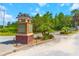 Doral Pointe community entrance sign amidst landscaped greenery and blue skies at 4720 Doral Pointe Dr, Kissimmee, FL 34758
