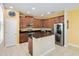 Modern kitchen with stainless steel appliances, wood cabinets, stone counter tops and kitchen island at 4720 Doral Pointe Dr, Kissimmee, FL 34758