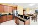 Open layout kitchen features wood cabinets, stone countertops, and stainless steel appliances at 4720 Doral Pointe Dr, Kissimmee, FL 34758