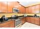 Well-lit kitchen features a stainless steel oven, range, microwave, and wooden cabinets at 4720 Doral Pointe Dr, Kissimmee, FL 34758