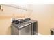 Modern laundry room features Samsung washer and dryer set, complemented by overhead wire shelving for optimal storage at 4720 Doral Pointe Dr, Kissimmee, FL 34758