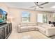 Bright living room with neutral tones features a ceiling fan and a comfy looking sectional sofa at 4720 Doral Pointe Dr, Kissimmee, FL 34758