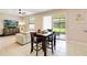 Well-lit living room with a white sectional sofa and a dark wood dining table at 4720 Doral Pointe Dr, Kissimmee, FL 34758