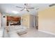 Bright living room and open kitchen layout with wood cabinets and yellow accent wall at 4720 Doral Pointe Dr, Kissimmee, FL 34758