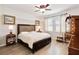 A well-lit main bedroom featuring stylish furnishings, wood flooring, and soft, natural light at 4720 Doral Pointe Dr, Kissimmee, FL 34758