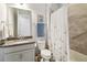 Bathroom featuring granite vanity, toilet, and tiled tub-shower combo with shower curtain at 5025 Sunfalls Ave, St Cloud, FL 34772