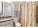 Bathroom featuring a vanity with granite countertop and a shower-tub combo at 5025 Sunfalls Ave, St Cloud, FL 34772