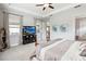 Neutral bedroom with tray ceiling, mounted television, and adjacent doorway at 5025 Sunfalls Ave, St Cloud, FL 34772