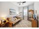 Cozy room with carpet, features a futon sofa bed, display cabinet, and natural light at 5025 Sunfalls Ave, St Cloud, FL 34772