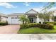 Charming single-story home with a two-car garage, landscaped front yard, and inviting front porch at 5025 Sunfalls Ave, St Cloud, FL 34772