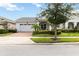 Charming single-story home with a two-car garage, landscaped front yard, and inviting front porch at 5025 Sunfalls Ave, St Cloud, FL 34772