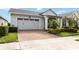Charming single-story home with a two-car garage and a brick paved driveway at 5025 Sunfalls Ave, St Cloud, FL 34772