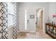 Welcoming foyer with tile flooring, front door with glass inset, and view into hallway at 5025 Sunfalls Ave, St Cloud, FL 34772