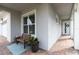Inviting front porch with brick flooring, bench seating, and view of entry door at 5025 Sunfalls Ave, St Cloud, FL 34772
