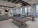 Upscale game room featuring pool tables, comfortable seating, and contemporary lighting at 5025 Sunfalls Ave, St Cloud, FL 34772