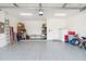 Spacious garage with epoxy flooring, ample storage space, and overhead lighting at 5025 Sunfalls Ave, St Cloud, FL 34772