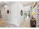 Hallway featuring white wainscoting and tile floors, leading to living areas at 5025 Sunfalls Ave, St Cloud, FL 34772