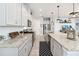 Modern kitchen boasting granite counters, subway tile backsplash, stainless appliances, and custom lighting at 5025 Sunfalls Ave, St Cloud, FL 34772