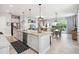 Open-concept kitchen featuring a large island with granite countertops, stainless steel appliances and casual seating at 5025 Sunfalls Ave, St Cloud, FL 34772