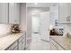 Bright kitchen featuring light gray cabinetry, granite countertops, and stainless wine rack at 5025 Sunfalls Ave, St Cloud, FL 34772